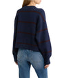 Model wearing a navy blue button-front cardigan with subtle horizontal stripe details and light-wash jeans.