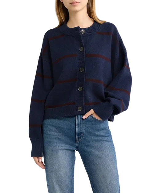 Model wearing a navy blue button-front cardigan with subtle horizontal stripe details and light-wash jeans.