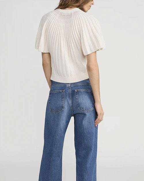 Back view of a person wearing a cream-colored ribbed knit short-sleeve cardigan with a fitted waistband, paired with high-waisted blue jeans featuring two back pockets and visible stitching.