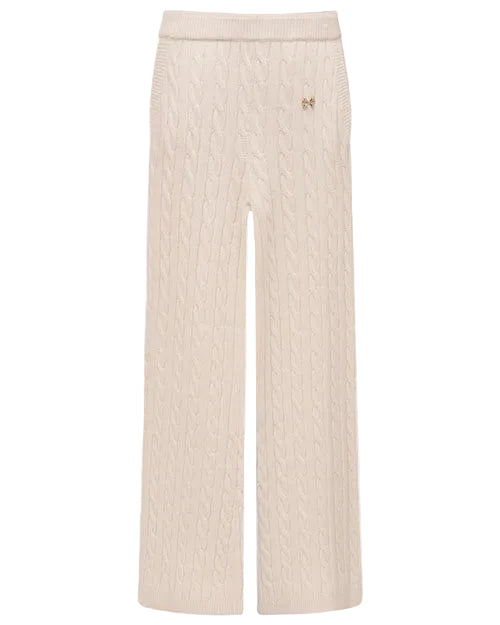 Cream-colored cable-knit wide-leg pants with an elastic waistband and ribbed hem. The pants feature a textured cable pattern throughout and a small decorative emblem near the waist.