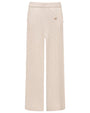 Cream-colored cable-knit wide-leg pants with an elastic waistband and ribbed hem. The pants feature a textured cable pattern throughout and a small decorative emblem near the waist.