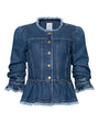 Front view of a cropped denim peplum jacket with a round neckline, front button closure, structured seam detailing, long sleeves with gathered ruffled cuffs, and frayed trim along the collar, cuffs, and hem, displayed against a white background.
