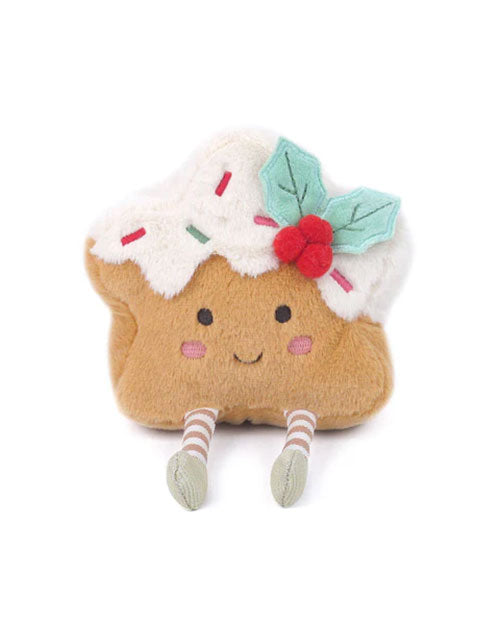  A plush toy shaped like a festive holiday treat, featuring a light brown base with a white icing top decorated with red and green sprinkles. The toy has a smiling face, rosy cheeks, and two small legs with striped stockings and green shoes. A green felt holly leaf with red berries is attached to the top for a cheerful holiday touch.