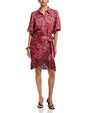 Red paisley print wrap dress with short sleeves, button-front detail, side tie waist, and fringed hem