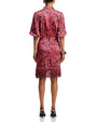 Red paisley print wrap dress with short sleeves, button-front detail, side tie waist, and fringed hem