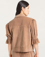 Back view of a light brown velvet jacket featuring a pointed collar, structured seams, and elbow-length puff sleeves with gathered cuffs.