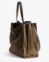 Side view of an brown leather tote bag with a structured silhouette, dual top handles, and a detachable shoulder strap. The design features soft, slightly textured leather and visible seam detailing.