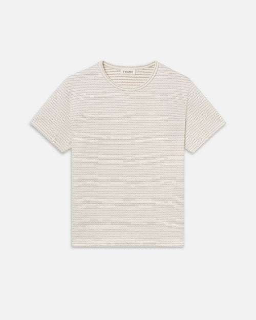 Product image of a cream short-sleeve crewneck T-shirt displayed flat against a light background, featuring subtle horizontal ribbed texture, a clean neckline, and a simple, minimal silhouette.