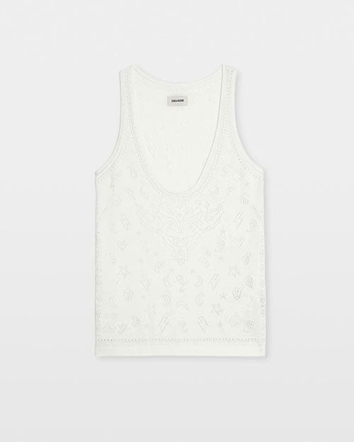 A white knit tank top featuring an open‑work embroidered design made up of small decorative symbols and patterns across the front. The top has a deep scoop neckline, wide shoulder straps, and a straight hem. It is displayed against a plain light background.