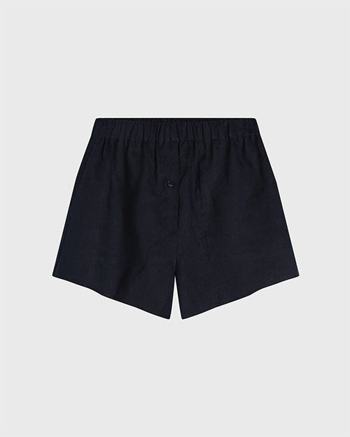 Dark navy linen shorts with an elastic waistband and a single button detail at the front, displayed against a light gray background.