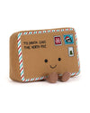 Plush toy shaped like a brown envelope addressed to Santa Claus at the North Pole, featuring a smiling face with black button eyes, red-white-blue striped edges, three festive stamps, and two small feet at the bottom.