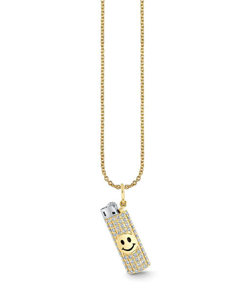 Gold chain necklace with a pendant shaped like a lighter, encrusted with sparkling stones and featuring a smiley face on the front. The lighter’s top is silver, contrasting with the jeweled gold body.