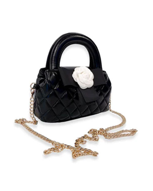 Small black quilted handbag with rounded top handles, decorated with a large white flower and black bow, featuring a gold-tone chain shoulder strap.