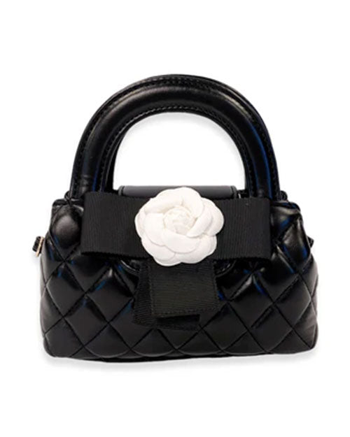 Small black quilted handbag with rounded handles, featuring a large black ribbon and a white fabric flower embellishment on the front.