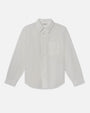 Product image of a lightweight off-white long-sleeve button-down shirt displayed flat against a light background, featuring a pointed collar, full button front with tonal buttons, and a single chest pocket. The shirt has a smooth, minimal design with a gently curved hem and a relaxed, tailored silhouette.