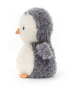 Side view of a plush penguin toy with a fluffy gray back and wings, white belly, and orange beak and feet. The penguin has small black eyes and a rounded body, giving it a soft and cuddly appearance.