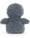 Back view of a plush penguin toy with a fluffy gray texture covering its entire body, including the head, wings, and back. The toy has a rounded shape and soft, curly fur.