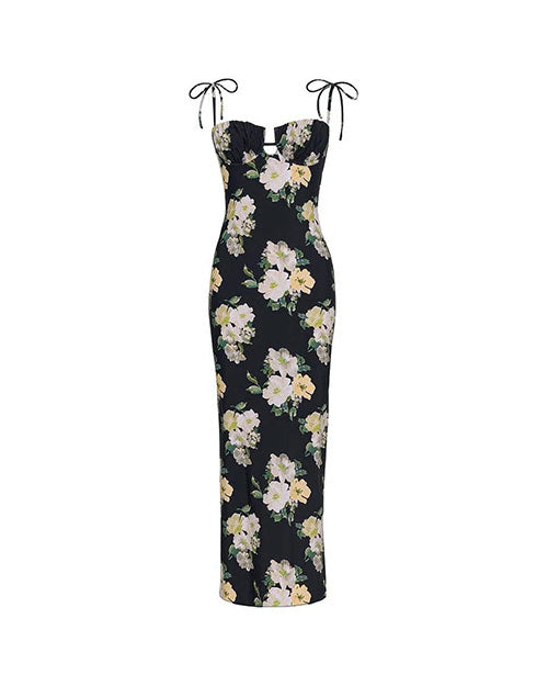Black sleeveless maxi dress with thin tie straps and a large floral print featuring white and light yellow flowers with green leaves.