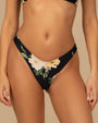Black bikini swim bottom with a large floral print featuring white and light yellow flowers with green leaves.