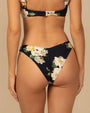 Back view of a black bikini swim bottom with a large floral print featuring white and light yellow flowers with green leaves.