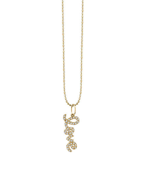 Gold necklace with a pendant spelling “love” in cursive script, encrusted with small sparkling diamonds, on a beaded gold chain.