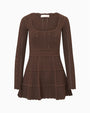 Brown knit mini dress with long sleeves and a scoop neckline, displayed against a light gray background. The dress features an intricate pointelle knit pattern throughout, a fitted bodice, a defined waist with scalloped trim, and a three-tiered flared skirt with matching scalloped edges.
