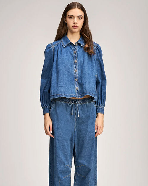 Blue denim set featuring a cropped button-up top with puffed sleeves and matching high-waisted drawstring pants.