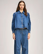 Blue denim set featuring a cropped button-up top with puffed sleeves and matching high-waisted drawstring pants.