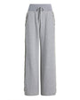 Front view of gray wide-leg pants featuring a high ribbed waistband with a drawstring tie and ruffled trim running down the outer sides of both legs.