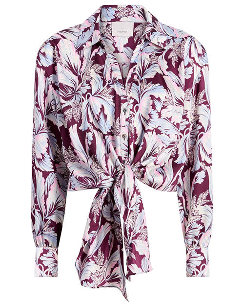 Front view of a long-sleeve button-up blouse with a bold, abstract feather-like pattern in shades of purple, lavender, and light blue. The blouse features a pointed collar and a tie-front detail at the waist.