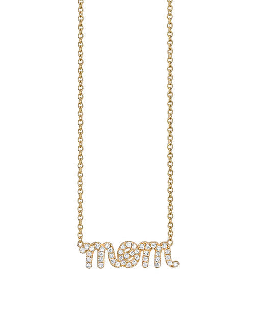 Gold necklace with a pendant spelling “mom,” encrusted with small sparkling diamonds, hanging from a delicate chain.