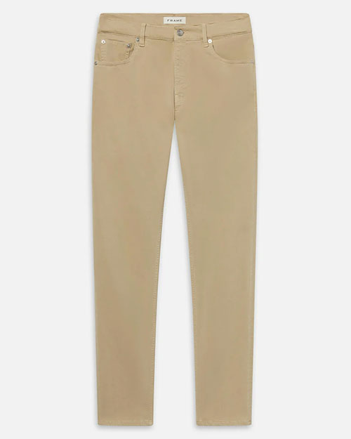 Product image of tan slim-fit pants displayed flat against a light background, featuring a mid-rise waist with belt loops, a button and zip closure, and classic five-pocket styling with metal rivets. The pants have a clean, tailored silhouette with straight, narrow legs and minimal visible fading.