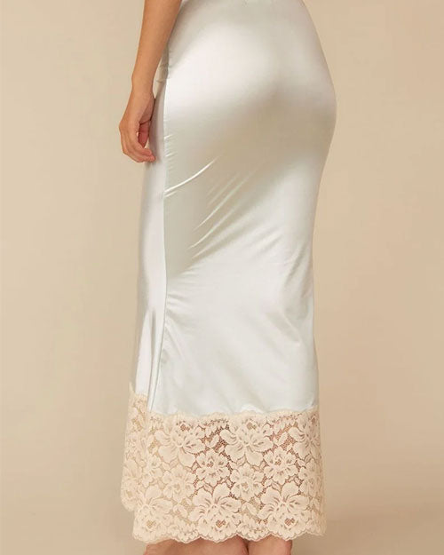 Back view of a person shown from the mid‑torso to the ankles is wearing a long, pale mint satin skirt. The skirt has a smooth, slightly glossy finish and a fitted silhouette that flares subtly toward the hem. The bottom portion features a wide band of cream-colored floral lace extending upward from the edge, adding contrast and texture.