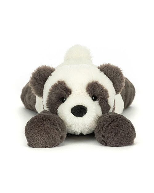 Plush toy resembling a panda bear with a white face, black eye patches, nose, and ears, white body, black limbs and tail, lying flat on its stomach with front legs stretched forward.