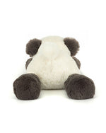 Plush toy of a panda bear lying on its stomach with head facing away, featuring white body fur and black ears, arms, and legs.