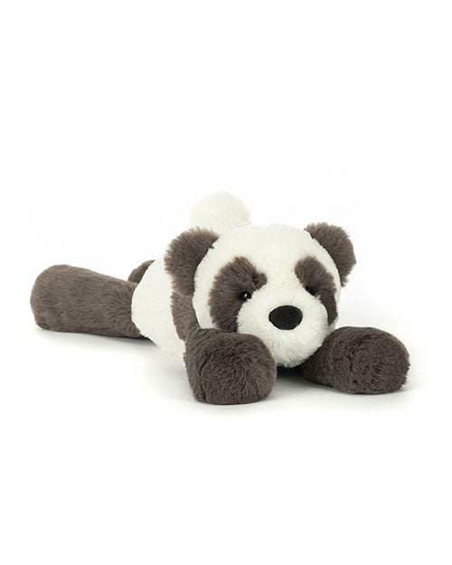 Plush toy shaped like a panda bear with black and white fur, black ears, arms, legs, and eye patches, lying down with front paws stretched forward.