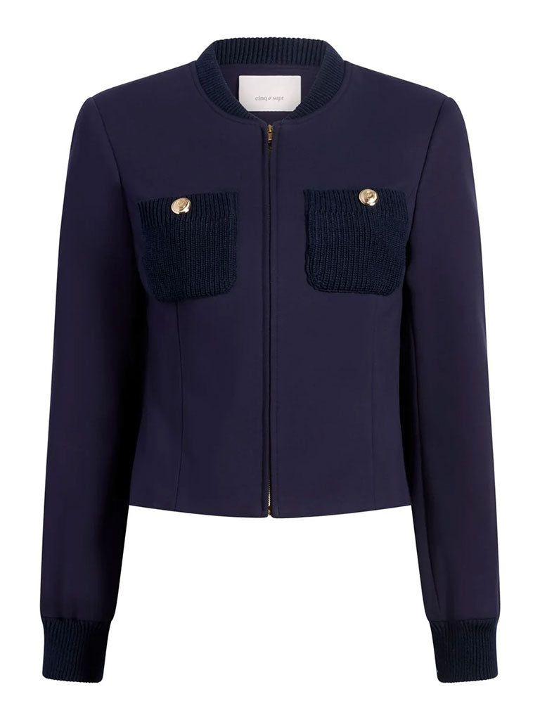 Navy zip‑front jacket with a round collar, long sleeves, and two textured knit patch pockets accented by gold buttons.