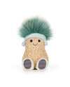 Plush toy resembling a peanut with a fuzzy textured body, black stitched eyes and smile, wearing a light blue headband with fluffy green hair, and white feet with gray-striped soles.