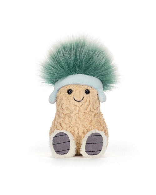 Plush toy resembling a peanut with a fuzzy textured body, black stitched eyes and smile, wearing a light blue headband with fluffy green hair, and white feet with gray-striped soles.