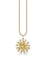 Gold necklace featuring a round starburst pendant adorned with multiple small diamonds. The pendant hangs from a delicate gold chain with a polished finish.