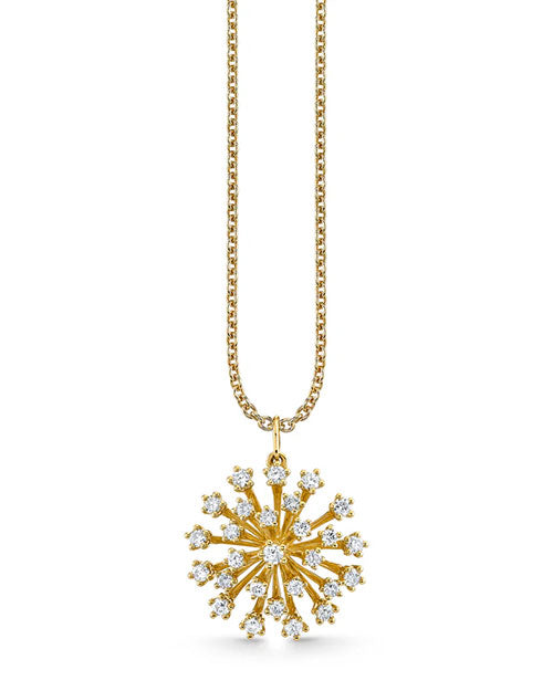 Gold necklace featuring a round starburst pendant adorned with multiple small diamonds. The pendant hangs from a delicate gold chain with a polished finish.