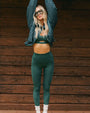 Person wearing a matching green textured sports bra and leggings set