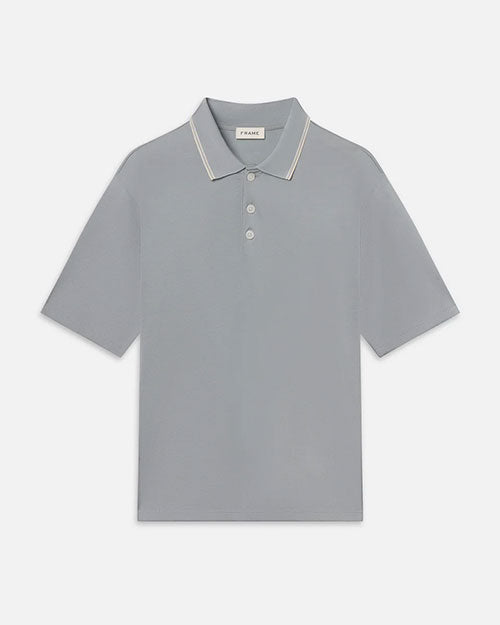 Product image of a short-sleeve polo shirt displayed flat against a light background, featuring a soft gray color, a classic collar with subtle contrast tipping, a three-button placket, and a clean, minimal silhouette.