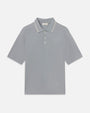 Product image of a short-sleeve polo shirt displayed flat against a light background, featuring a soft gray color, a classic collar with subtle contrast tipping, a three-button placket, and a clean, minimal silhouette.