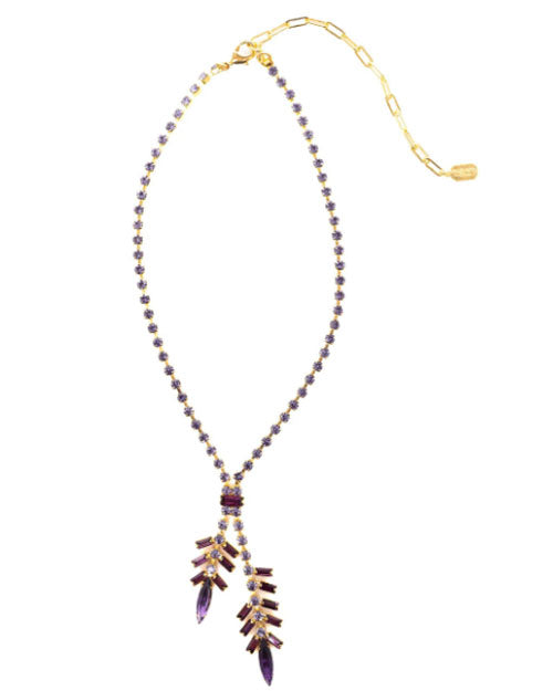 A gold-toned necklace with a Y-shaped design, featuring a chain of small purple crystals and two dangling pendants made of marquise and baguette-cut purple stones arranged in a branch-like pattern, displayed on a white background.
