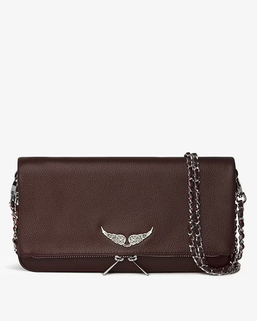 Front view of a dark brown leather handbag with a silver wing-shaped embellishment on the flap and a silver chain strap draped across the bag.