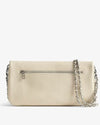 Back view of a beige leather handbag t featuring a silver zipper pocket and a silver chain strap draped across the bag.