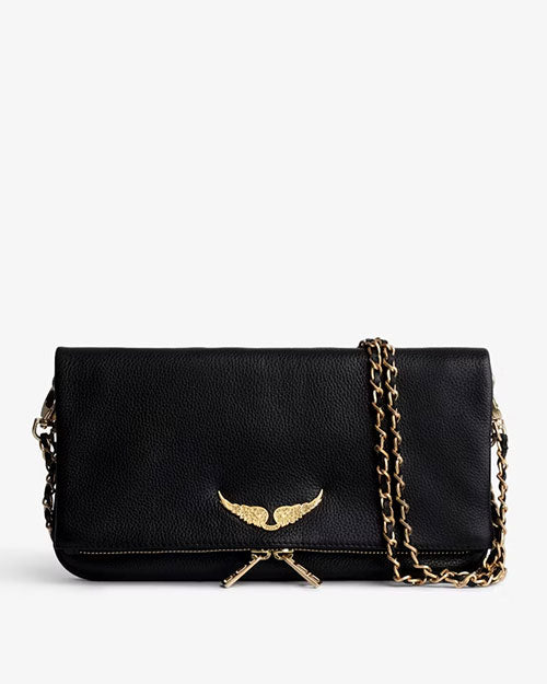 Black leather clutch bag with a gold wing emblem on the front flap, featuring a gold chain strap and zipper detail, displayed against a light background.