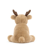 Back view of a plush deer toy with light brown fur, darker brown antlers, small round ears, and a fluffy texture, seated with legs spread out to the sides.