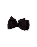 Neatly tied black bow tie with symmetrical loops and tails, typically worn with formal attire such as tuxedos or suits.